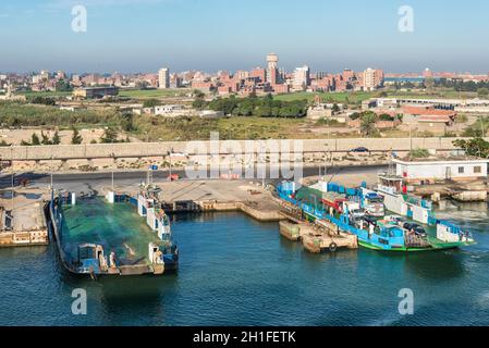 El Qantara, Egypt - November 5, 2017: Cars Ferryboats moored to the shore on the Suez Canal in the city El Qantara located in the Egyptian governorate Stock Photo