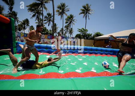 salvador, bahia / brazil - october 25, 2019: people are seen playing football on an inflatable mattress with soap and water in the city of Salvador. * Stock Photo