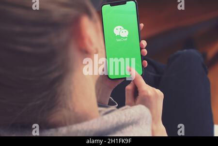 KYIV, UKRAINE-JANUARY, 2020: Wechat on Smart Phone Screen. Young Girl Pointing or Texting Smartphone During a Pandemic Self-Isolation and Coronavirus Stock Photo