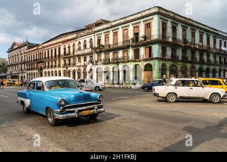 Havana, Cuba - September 10, 2013: Classic old blue American car being used as a taxi in downtown Havana, Cuba, with locals. On the right you can see Stock Photo