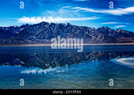 Lake Crowley Reflections - On the East shores of Crowley Lake, a little East of Mammoth, looking towards the Sierras, with some ice on the lake. Stock Photo