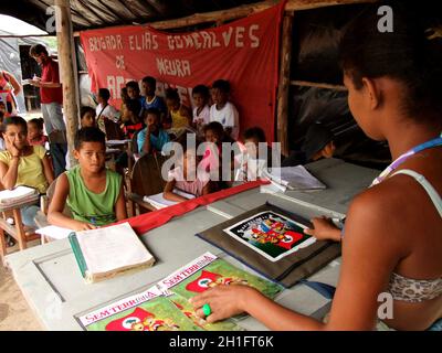 eunapolis, bahia / brazil - november 24, 2010: Member of the Landless Movement - MST - they are seen in a makeshift school camp on the banks of the BR Stock Photo