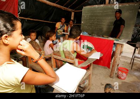 eunapolis, bahia / brazil - november 24, 2010: Member of the Landless Movement - MST - they are seen in a makeshift school camp on the banks of the BR Stock Photo