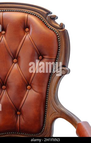 Closeup of half of a classic armchair backrest with armrest. Isolated on white background – Clipping path attached. Genuine leather, solid wood... Stock Photo