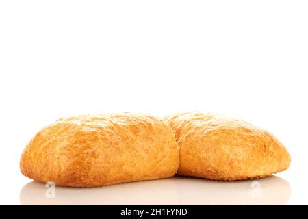 One whole and one half fragrant ciabatta, close-up, isolated on white. Stock Photo
