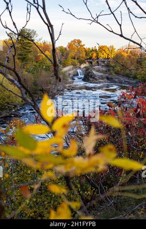 The Hog's Back Falls and Bridge, Prince of Wales Falls waterfalls on the Rideau River in Ottawa, Canada in autumn. Colorful nature in park with river Stock Photo