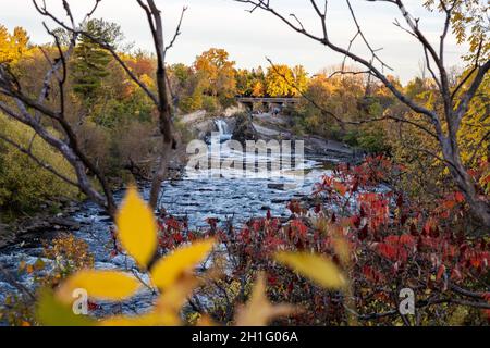 The Hog's Back Falls and Bridge, Prince of Wales Falls waterfalls on the Rideau River in Ottawa city of Canada in autumn. Colorful nature in park with Stock Photo