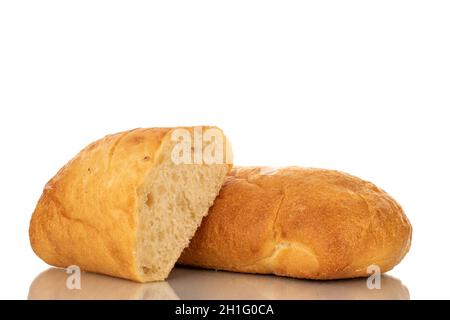 One whole and one half fragrant ciabatta, close-up, isolated on white. Stock Photo