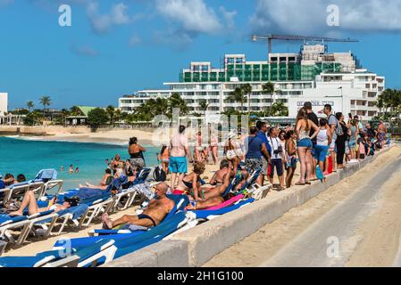 St. Maarten, Netherlands - December 17, 2018: People on Maho beach are waiting for the planes to land at the Princess Juliana airport in Sint Maarten Stock Photo