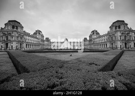 Paris, France - December 23, 2018: Louvre museum in Paris, France. It is one of the top tourist attractions of Paris. Paris landmark in black and whit Stock Photo