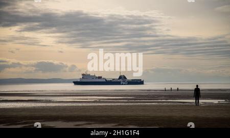 Ferry boat coming into the river Mersey Liverpool UK early evening sunshine off Crosby beach Stock Photo