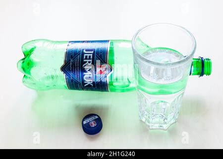 MOSCOW, RUSSIA - JUNE 16, 2020: above view of lying empty plastic bottle of Jermuk and glass with water on table. Jermuk is mineral water from the tow Stock Photo