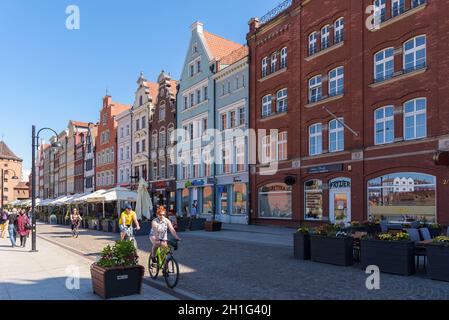 Gdansk, Poland - June 14, 2020: People ride bike picturesque Stagiewna street in city downtown Stock Photo
