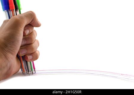 Multicolored pens in hand isolated on white background. Lines on white. Copy space Stock Photo