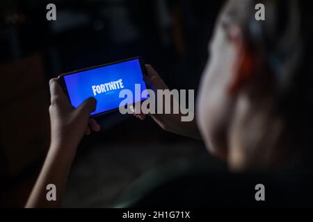 Bucarest, Romania - June 25. 20202: Image a child playing Fortnite, a game by Epic Games, on a mobile phone in Bucharest, Romania. Stock Photo