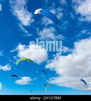 Foil kites against blue sky. Stock Photo