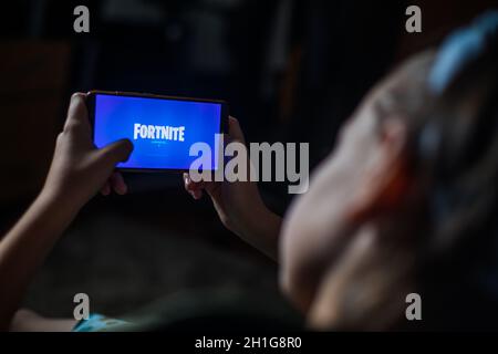 Bucarest, Romania - June 25. 20202: Image a child playing Fortnite, a game by Epic Games, on a mobile phone in Bucharest, Romania. Stock Photo