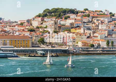 Lisbon, Portugal - May 19, 2017: View of Lisbon city with old architecture from cruise ship, Portugal. Sailing yacht in the foreground. Stock Photo