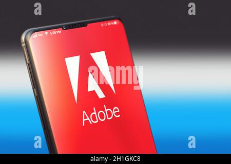 KYIV, UKRAINE-JUNE, 2020: Adobe Mobile Application on the Smart Phone Screen. Close Up Studio Shot of Smartphone with Adobe Application. Stock Photo