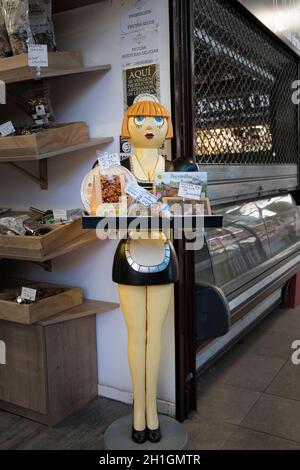 A pretty waitress statue displaying a tray of buscuits in the market in the city of Salamanca, Spain Stock Photo