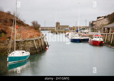 ANGLESEY, UK - February 28, 2012. Yacht and fishing boats in an old harbour, Amlwch Port, Anglesey, Wales Stock Photo