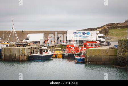 ANGLESEY, UK - February 28, 2012. Yacht and fishing boats in an old harbour, Amlwch Port, Anglesey, Wales Stock Photo