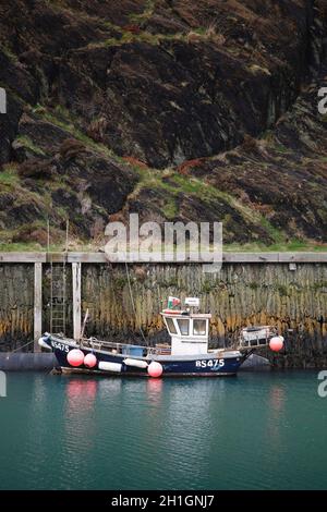 ANGLESEY, UK - February 28, 2012. Small fishing boats shelters in a harbour on the Welsh coast. Amlwch Port, Anglesey, Wales Stock Photo