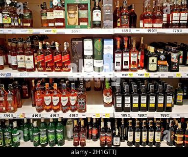 PRAGUE, CZECH REPUBLIC - AUGUST 07, 2020: Selection of various spirit bottles tagged with discount price tags on shelf in Tesco grocery store. Tesco w Stock Photo