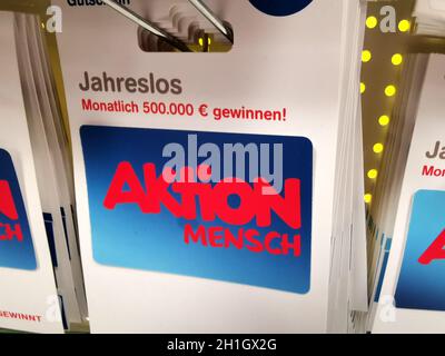 WETZLAR, GERMANY - DEZEMBER 18 2019: AKTION MENSCH Gift cards displayed for purchase in supermarket. Stock Photo