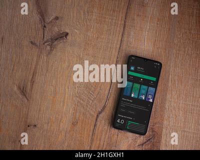 Lod, Israel - July 8, 2020: Bit app play store page on the display of a black mobile smartphone on wooden background. Top view flat lay with copy spac Stock Photo
