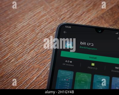 Lod, Israel - July 8, 2020: Bit app play store page on the display of a black mobile smartphone on wooden background. Top view flat lay with copy spac Stock Photo