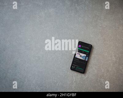 Lod, Israel - July 8, 2020: PAY app play store page on the display of a black mobile smartphone on ceramic stone background. Top view flat lay with co Stock Photo