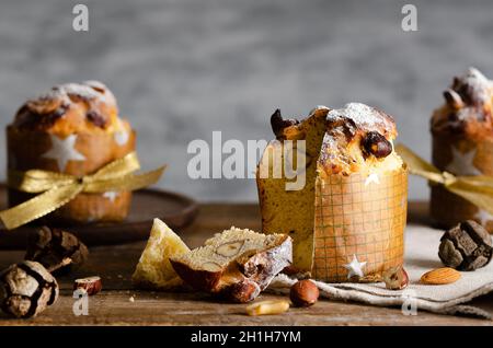 Mini panettone on a wooden plate and table. Stock Photo