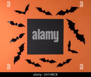 Creative Halloween background made of bats and black paper card. Minimal holiday concept. Flat lay. Stock Photo