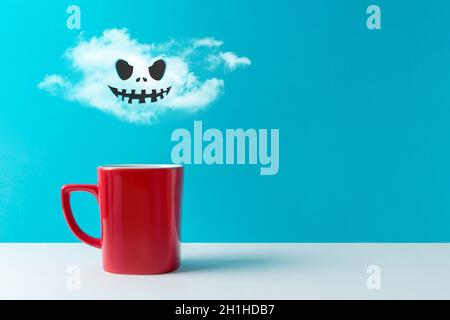 Halloween celebration concept with cup of coffee or hot drinks and bats on white table. Minimal holiday concept. Stock Photo