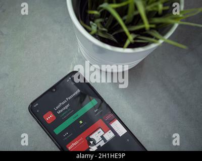 Lod, Israel - July 8, 2020: Modern minimalist office workspace with black mobile smartphone with LastPass Password Manager app play store page on marb Stock Photo