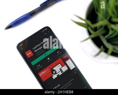 Lod, Israel - July 8, 2020: Modern minimalist office workspace with black mobile smartphone with LastPass Password Manager app play store page on whit Stock Photo