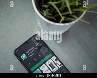 Lod, Israel - July 8, 2020: Modern minimalist office workspace with black mobile smartphone with Mint Browser app play store page on marble background Stock Photo