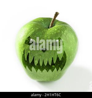 Halloween mask on a green apple. Halloween concept. Stock Photo