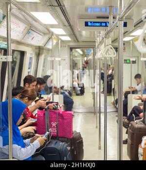 SINGAPORE - JAN 13, 2017: Passengers in Singapore Mass Rapid Transit (MRT) train. The MRT has 102 stations and is the second-oldest metro system in So Stock Photo