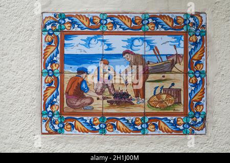 BARCELONA, SPAIN - JUNE 2, 2013: Picture of a mosaic depicting the fisher in Spain. An image of specially painted tiles and pieces of glaze on the wal Stock Photo