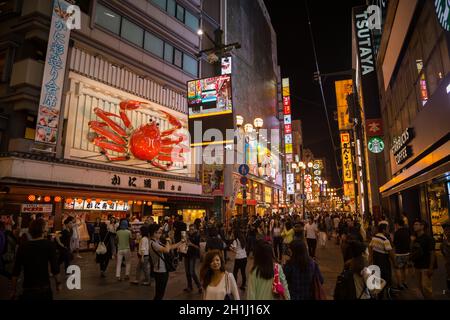 Osaka, Japan - September 22 2015: Tourist walking in a shopping street called Dotonbori Street. Giant moving crab on restaurant in Dotonbori Osaka, Na Stock Photo