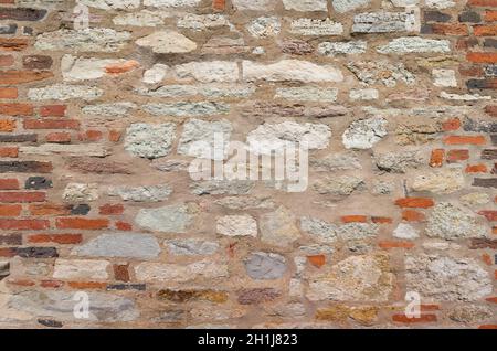Vintage red bricks and stones old wall texture background. Stock Photo