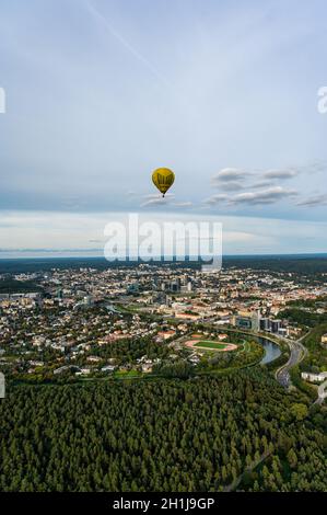 Vilnius, Lithuania - September 14, 2021: Yellow hot air balloon takes flight above Vilnius, Lithuania. Stock Photo