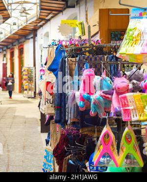 LARNACA, CYPRUS - FEBRUARY 16, 2019: Colorful gifts puppets, kitchen towels on stands at souvenir market in Larnaca touristic downtown Stock Photo