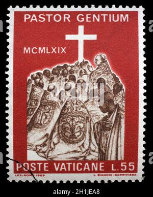 Stamp issued in Vatican shows Visit of the Pope Paul VI to Africa, circa 1969. Stock Photo