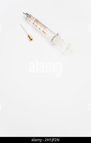 isolated sterilized glass injection syringe on a white surface Stock Photo