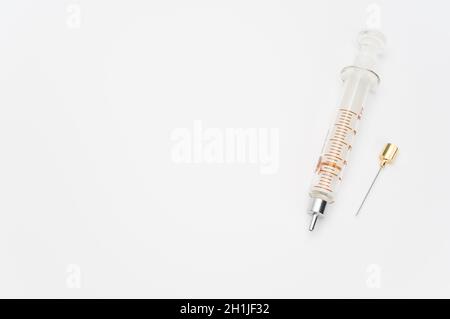 isolated sterilized glass injection syringe on a white surface Stock Photo