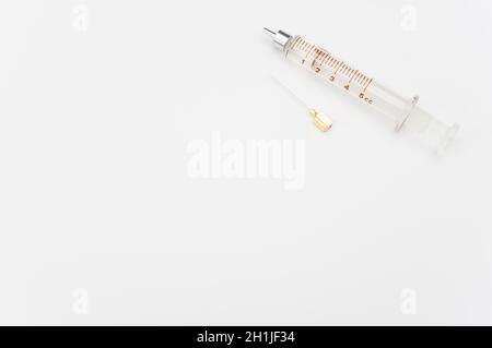 isolated sterilized glass injection syringe on a white surface Stock Photo