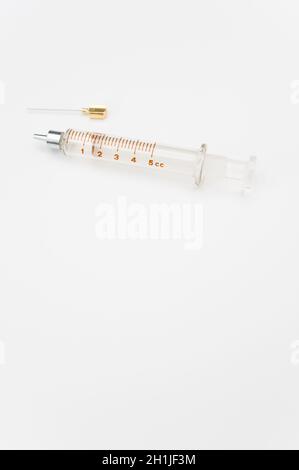 isolated sterilized glass injection syringe on a white surface Stock Photo